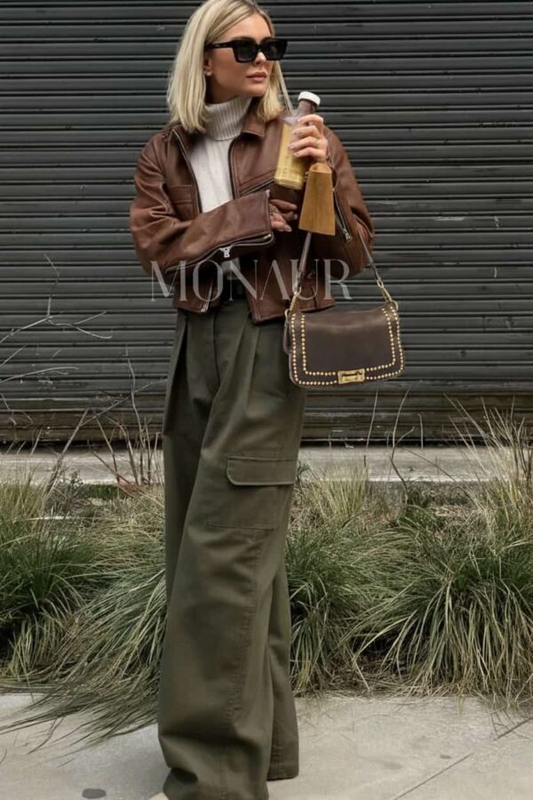 modelo portando el bolso en su antebrazo piel lavada italiana de tendencia con tachas y un look urbano